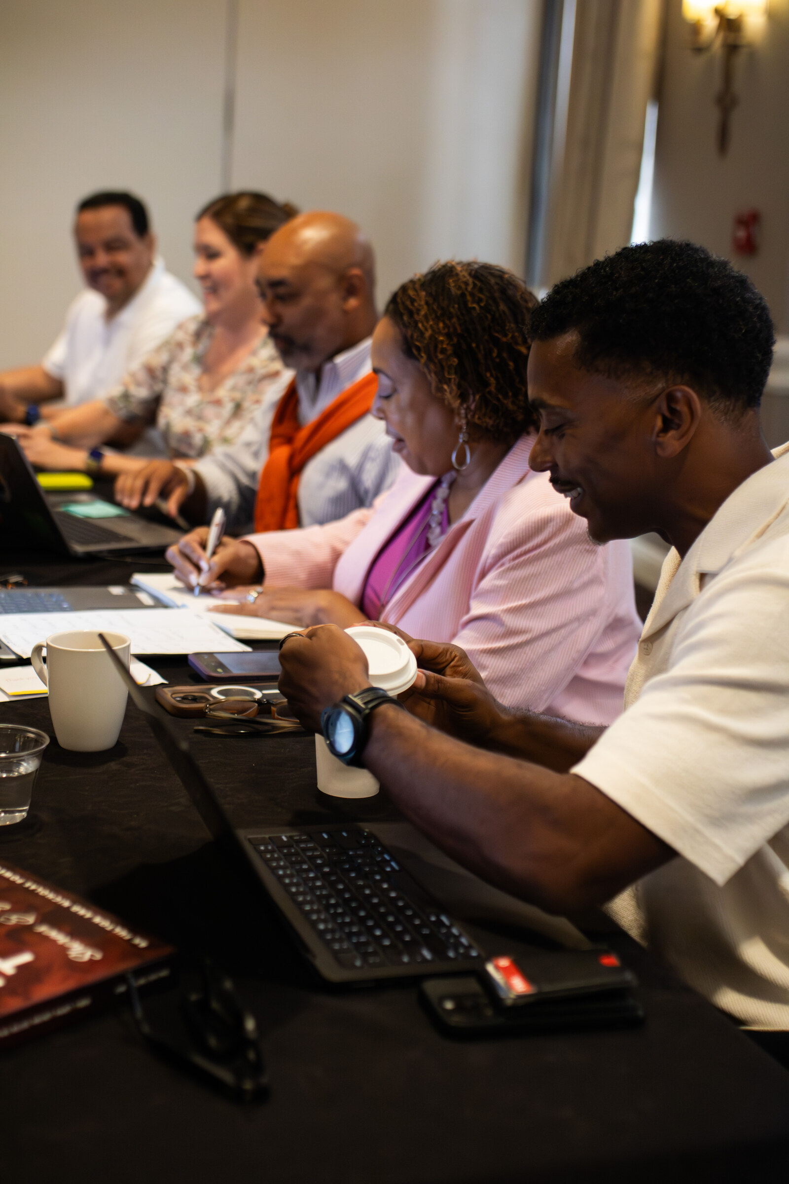 A business owner working at a laptop during a Council program