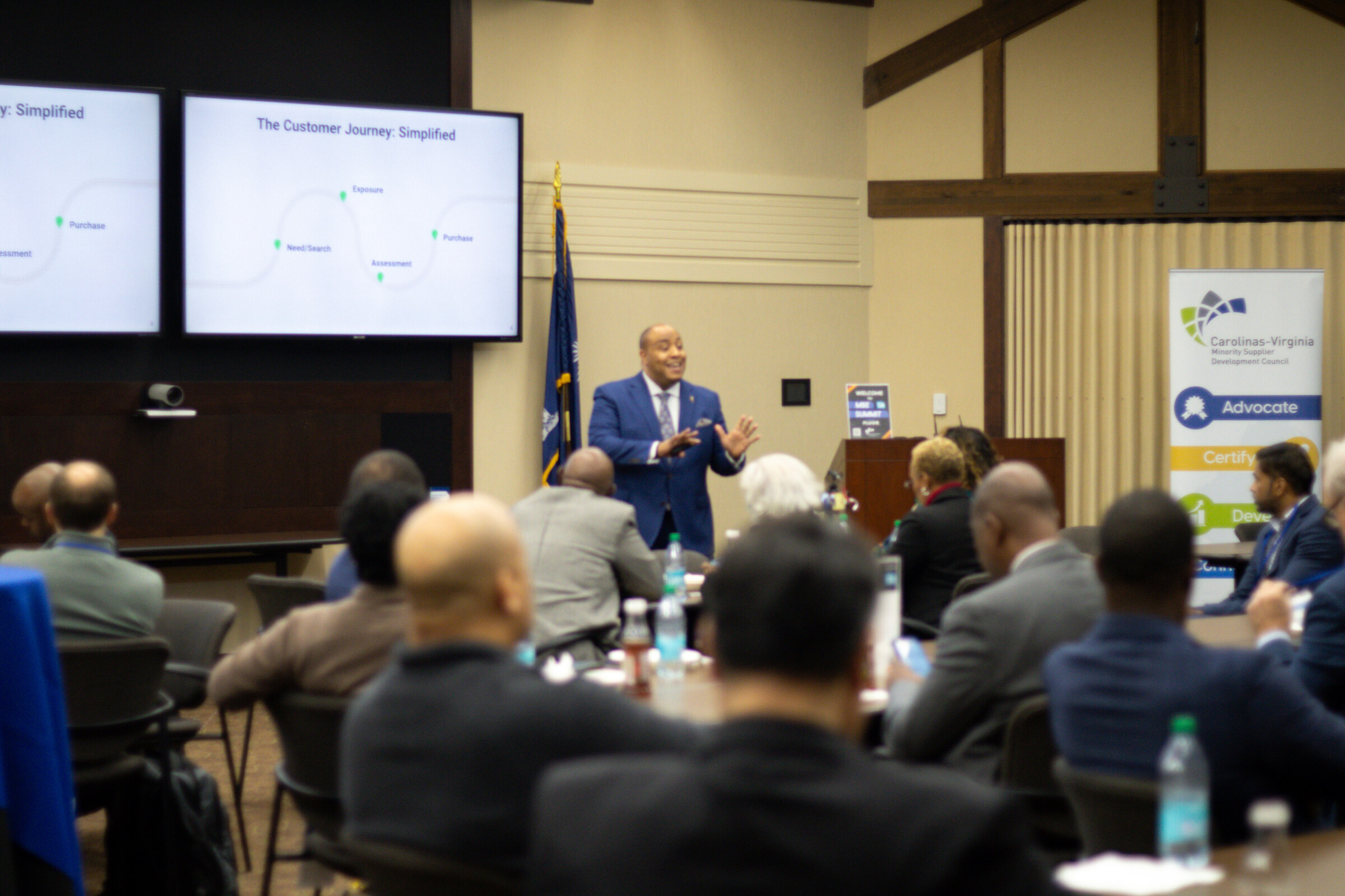 A presenter and audience during a Council business session